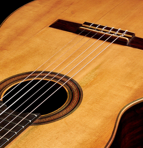 The soundboard and bridge of a 1918 Santos Hernandez classical guitar made with spruce and csa rosewood