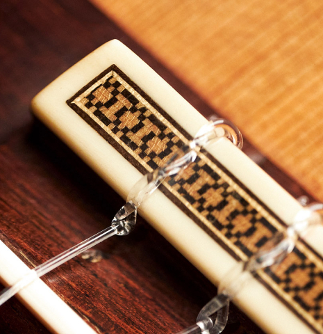 The bridge, tie-block and saddle of a 1973 Hernandez y Aguado classical guitar made of cedar and CSA rosewood
