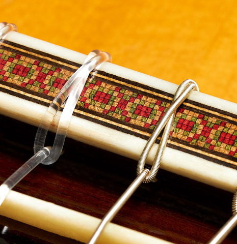 The bridge, tie-block and saddle of a 1964 Hernandez y Aguado classical guitar made of spruce and CSA rosewood
