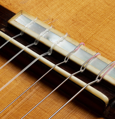 The bridge, tie-block and saddle of a 1931 Santos Hernandez classical guitar made of spruce and CSA rosewood (ex David Gómez Tárrega)