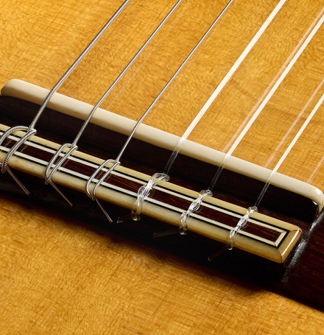 The bridge, tie-block and saddle of a 1941 Santos Hernandez classical guitar made of spruce and CSA rosewood