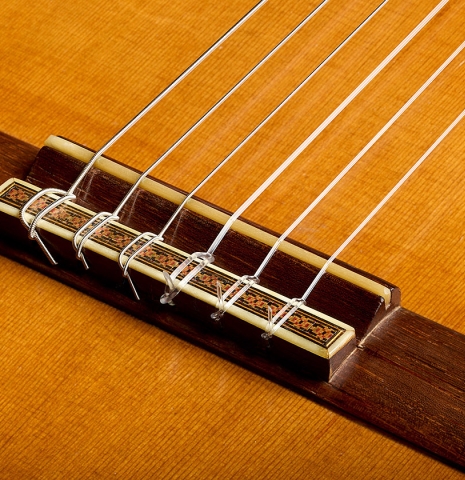 The bridge, tie-block and saddle of a 1970 Hernández y Aguado classical guitar made of cedar and CSA rosewood