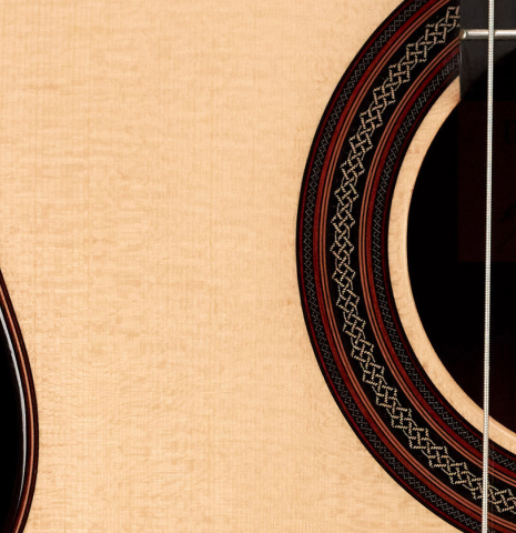 The top and detail of the rosette of a 2023 Dietmar Heubner classical guitar made with spruce and African rosewood