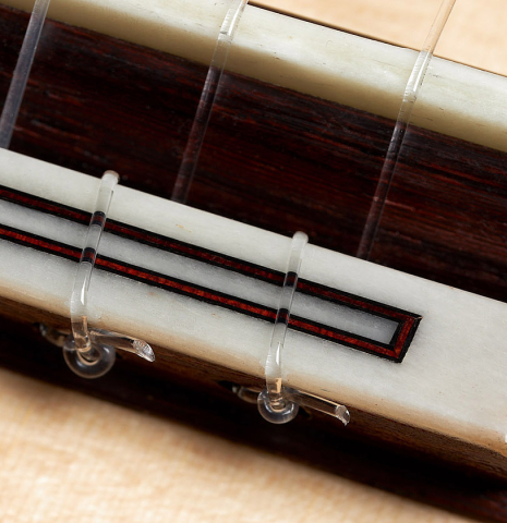 The bridge, tie-block and saddle of a 2024 Dietmar Heubner "Bois de Rose" classical guitar made with spruce and African rosewood