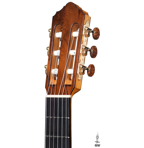 The headstock of a 2021 Dietmar Heubner classical guitar made of spruce and cocobolo on a white background.