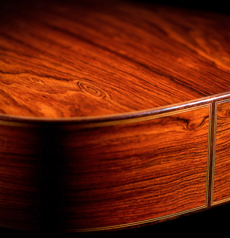 Sides and back at the foot of a 2021 Dietmar Heubner classical guitar made of spruce and cocobolo.