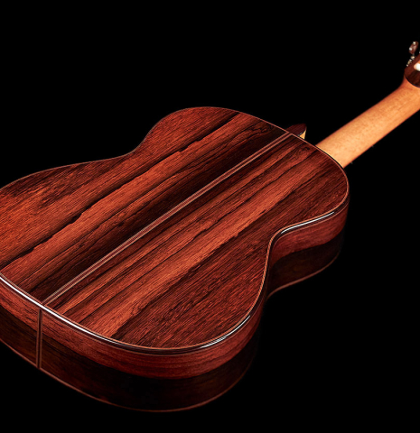 The back and sides of a 2022 Dietmar Heubner classical guitar made with cedar and African rosewood