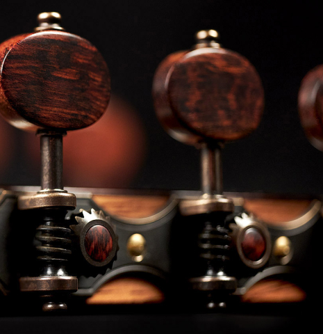 The headstock and tuners of a 2022 Dietmar Heubner classical guitar made with cedar and African rosewood