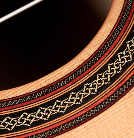 The rosette of a 2022 Dietmar Heubner classical guitar made with cedar and African rosewood