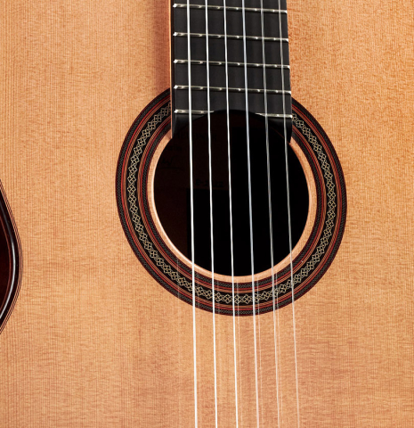 The front and rosette of a 2022 Dietmar Heubner classical guitar made with cedar and African rosewood