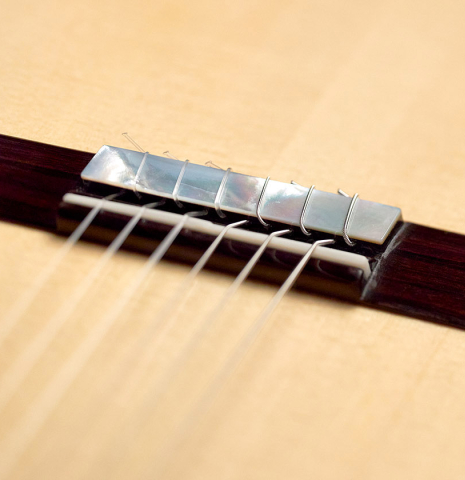 This is the bridge, tie-block and saddle of a 2022 Kenny Hill &quot;Signature SP/CD&quot; SP/IN classical guitar