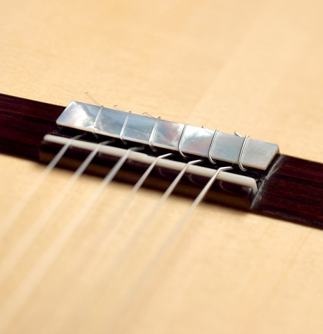 This is the bridge, tie-block and saddle of a 2022 Kenny Hill "Signature SP/CD" SP/IN classical guitar