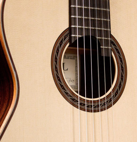The soundboard of a 2016 Kenny Hill "Performance" classical guitar made of spruce and Indian rosewood