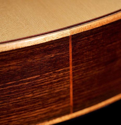 The lower bout of a 2016 Kenny Hill "Performance" classical guitar made of spruce and Indian rosewood