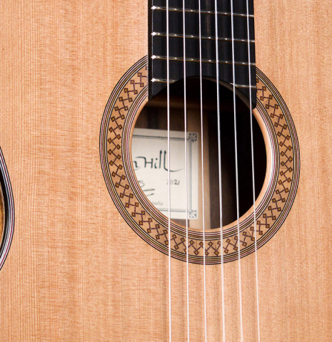 The soundboard of a 2021 Stephen Hill classical guitar made with cedar and exotic ebony