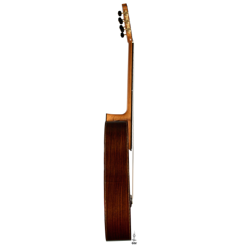 The side of a 2025 Kenny Hill "Signature CD/SP" classical guitar made of a cedar/spruce double top and Indian rosewood