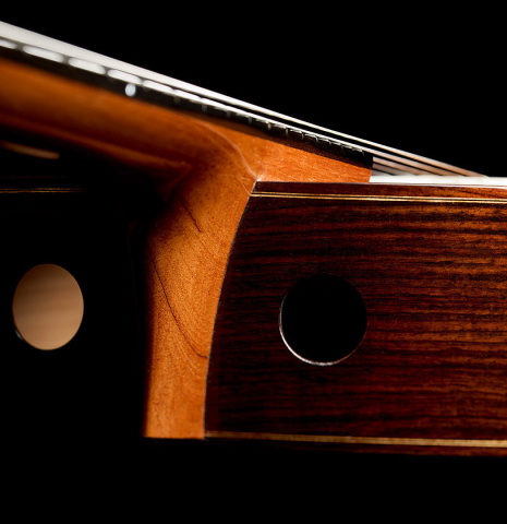 The sound ports on the sides of a 2025 Kenny Hill "Signature CD/SP" classical guitar made of a cedar/spruce double top and Indian rosewood