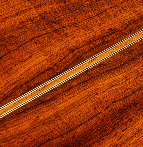 The back center seam of a 2021 Kenny Hill "Torres 640" classical guitar made of spruce and CSA rosewood