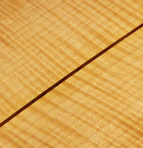The back center seam of a 2015 Kenny Hill "Performance 640 SP/CD" classical guitar made of spruce and maple