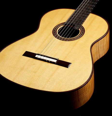 The soundboard of a 2015 Kenny Hill "Performance 640 SP/CD" classical guitar made of spruce and maple