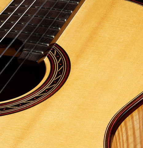 The top and rosette of a 2015 Kenny Hill "Performance 640 SP/CD" classical guitar made of spruce and maple