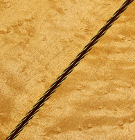 The back center seam of a 2009 Kenny Hill "Torres 640 Lattice Double Top" classical guitar made of spruce and maple