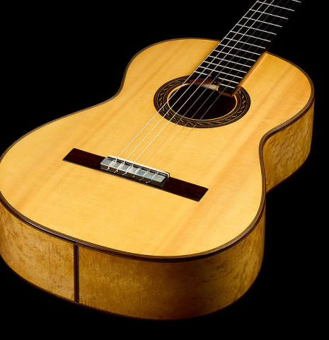 The top and sides of a 2009 Kenny Hill "Torres 640 Lattice Double Top" classical guitar made of spruce and maple