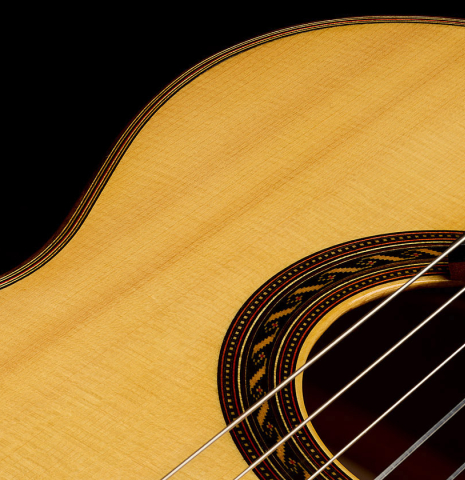 The soundboard and rosette of a 2009 Kenny Hill "Torres 640 Lattice Double Top" classical guitar made of spruce and maple