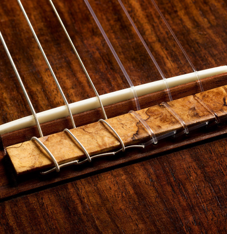 The bridge, tie-block and saddle of a 2025 Kenny Hill "Companion" classical guitar made of Indian rosewood for the top, back and sides