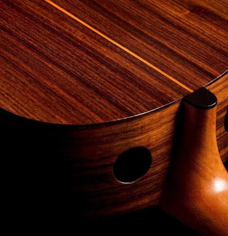 The heel, neck, back binding and soundports of a 2025 Kenny Hill "Companion" classical guitar made of Indian rosewood for the top, back and sides