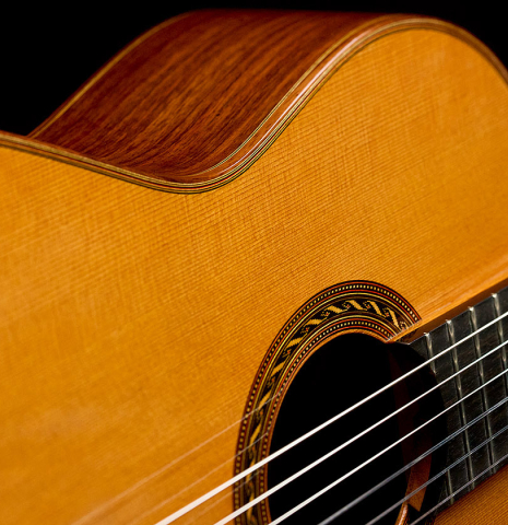 The soundboard and side of a 2010 Kenny Hill "Signature CD/SP" classical guitar with electronics made of cedar/spruce and Indian rosewood