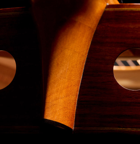 The dual soundports of a 2010 Kenny Hill "Signature CD/SP" classical guitar with electronics made of cedar/spruce and Indian rosewood