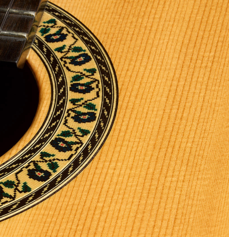 The soundboard and rosette of a 2020 Kenny Hill "Heritage" classical guitar made of spruce and Indian rosewood