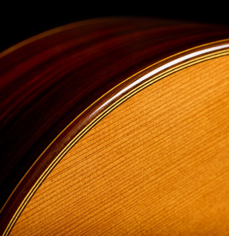 The top binding and purfling of a 2009 Dieter Hopf “Super Classic” classical guitar made of cedar and Indian rosewood