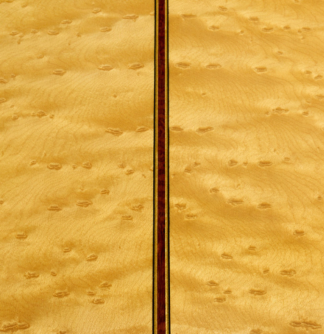 The back center seam of a 2017 Richard Howell classical guitar made of spruce and maple
