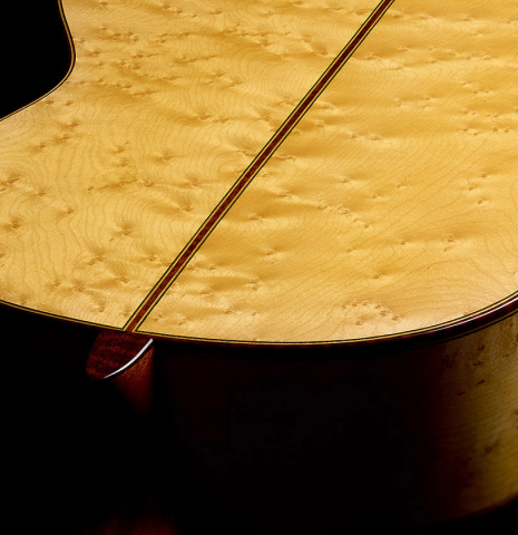 The heel, back binding and purfling of a 2017 Richard Howell classical guitar made of spruce and maple