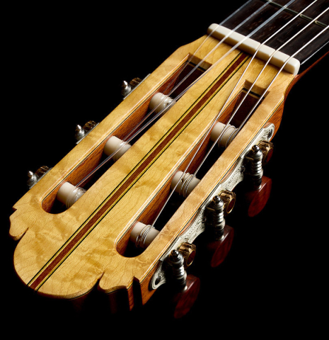 The headstock and tuning machines of a 2017 Richard Howell classical guitar made of spruce and maple