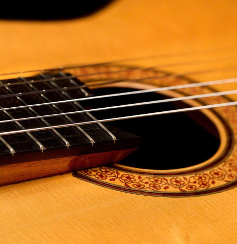 The elevated fingerboard and soundboard of a 1994 Thomas Humphrey "Millennium" classical guitar made with spruce and CSA rosewood