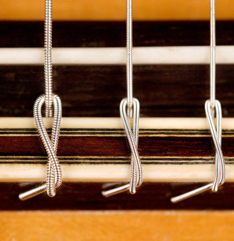 The bridge and saddle of a 1994 Thomas Humphrey "Millennium" classical guitar made with spruce and CSA rosewood