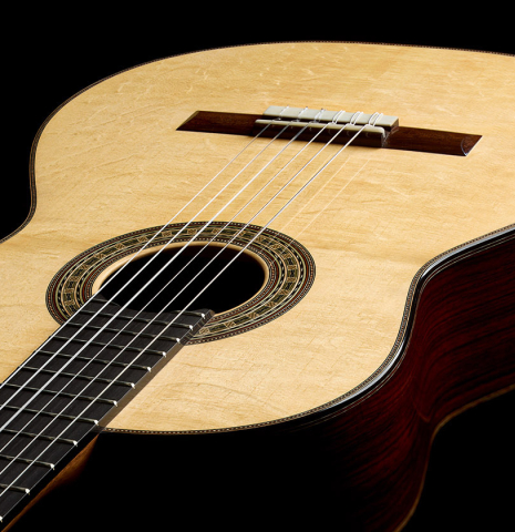 The top and sides of a 2025 Brian Itzkin classical guitar made of spruce and Indian rosewood