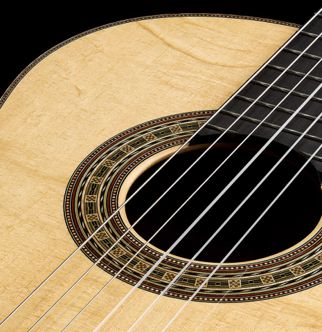 The soundboard and rosette of a 2025 Brian Itzkin classical guitar made of spruce and Indian rosewood