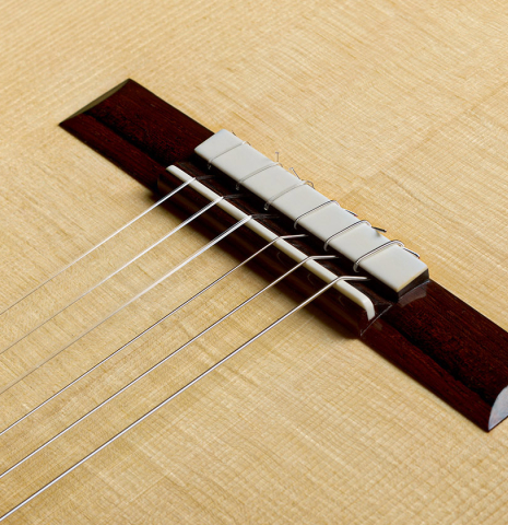 The soundboard and bridge of a 2026 Brian Itzkin "635" classical guitar made of spruce and African rosewood