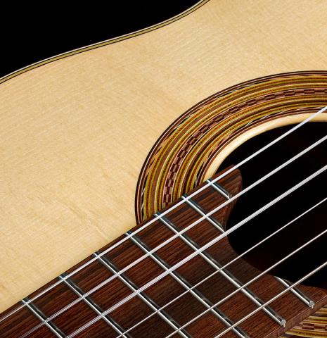 The fingerboard, top and rosette of a 2026 Brian Itzkin "635" classical guitar made of spruce and African rosewood