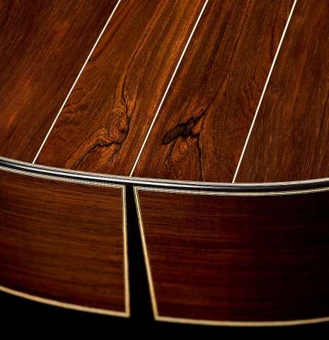 The foot where the sides come together at the four piece back of a 2026 Brian Itzkin "635" classical guitar made of spruce and CSA rosewood