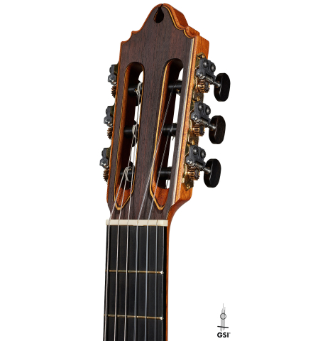The headstock of a 2002 Paul Jacobson classical guitar made of cedar and Indian rosewood