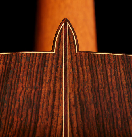 The heel, back binding and purfling of a 2002 Paul Jacobson classical guitar made of cedar and Indian rosewood