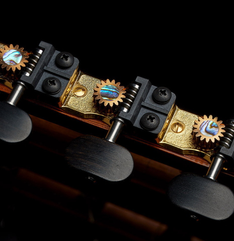 The John Gilbert tuning machines of a 2002 Paul Jacobson classical guitar made of cedar and Indian rosewood