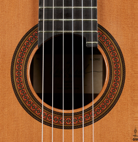 The rosette of a 2002 Paul Jacobson classical guitar made of cedar and Indian rosewood