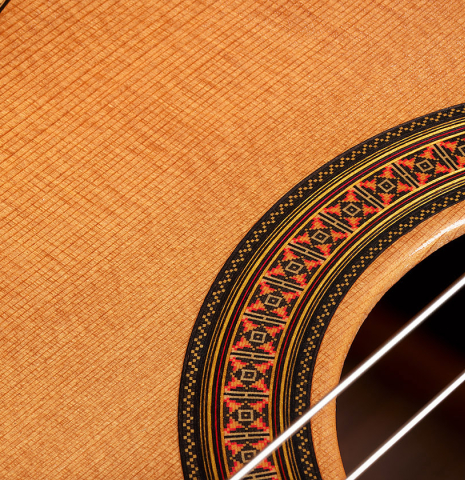 The soundboard and rosette detail of a 2002 Paul Jacobson classical guitar made of cedar and Indian rosewood