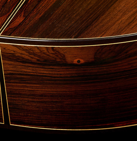 The back and sides at the foot of a 1997 Paul Jacobson classical guitar made of cedar and CSA rosewood